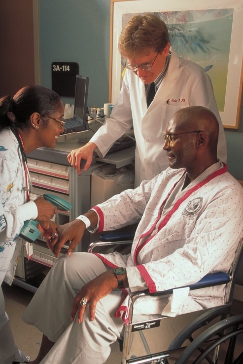 A nurse scanning a patient's wristband using a handheld barcode scanner at a Veterans Health Administration hospital.