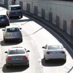 Cars driving through Webster Street Tube in Alameda, California, illustrating traffic and potential ALPR monitoring points.