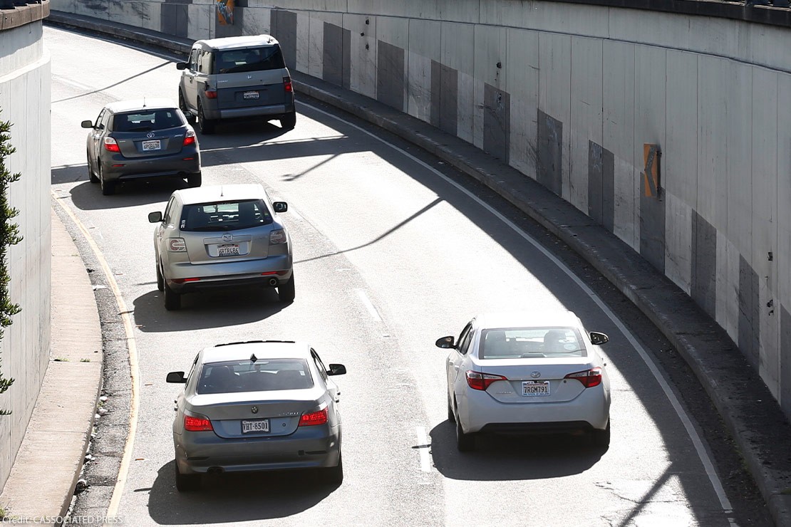 Cars driving through Webster Street Tube in Alameda, California, illustrating traffic and potential ALPR monitoring points.