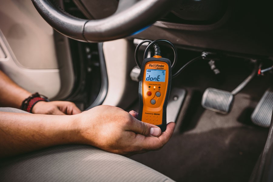 Dashboard view highlighting the location of the OBD2 port beneath the steering wheel