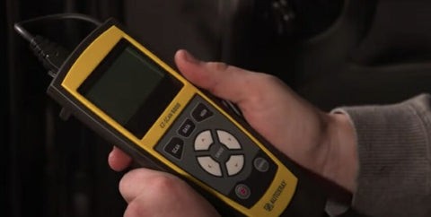 OBD2 scanner tool connected to a car port