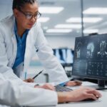 Neurologist and neurosurgeon reviewing a CT scan at an urgent care center, discussing patient diagnosis.