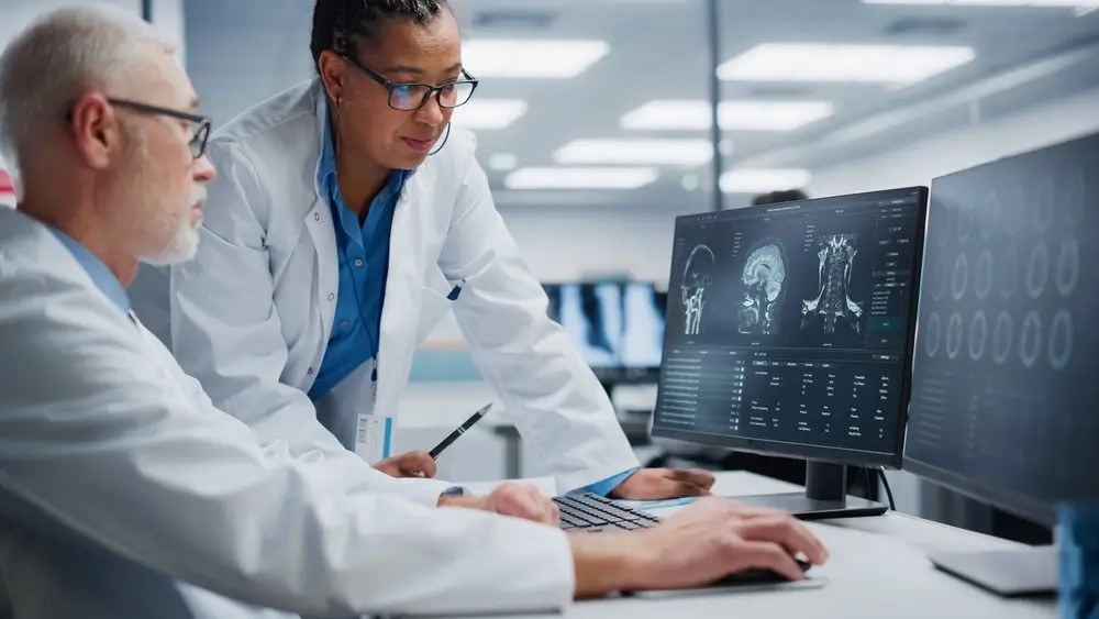 Neurologist and neurosurgeon reviewing a CT scan at an urgent care center, discussing patient diagnosis.